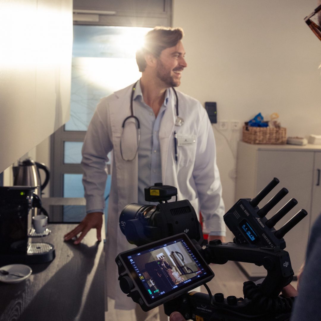 Behind the Scenes of an actor standing infront of a camera