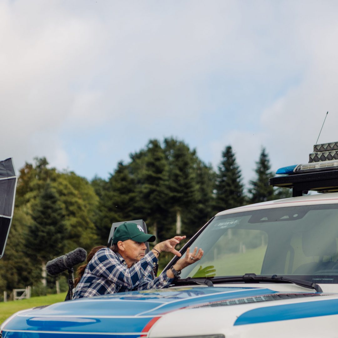 DP planning a shot infront of a car for a Black Forest Studios Microdrama Production